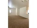 Inviting living room features neutral paint, carpet, and lots of natural light at 8756 Shady Pines Dr, Las Vegas, NV 89143