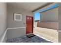 Inviting entryway features a red door, stylish paving, and modern architectural details at 9054 Tangerine Tree Ct, Las Vegas, NV 89113
