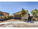 Single-story home with two car garage, a brick paved driveway, and desert landscaping at 9351 Aria Ridge Ave, Las Vegas, NV 89143