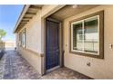 Close up of front door featuring a craftsman style door and stone walkway at 9351 Aria Ridge Ave, Las Vegas, NV 89143