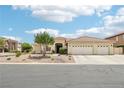 Lovely single-story home featuring desert landscaping, a three-car garage, and a tile roof on a sunny day at 9410 Stone Castle Way, Las Vegas, NV 89123