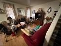 Cozy living room with wood floors and large windows providing plenty of natural light at 977 Country Skies Ave, Las Vegas, NV 89123
