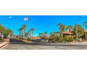 A street view of a well maintained community with palm trees and red-tiled roofs under a bright blue sky at 1097 Paradise Resort Dr, Henderson, NV 89002