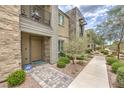 Beautiful townhome with desert landscaping, stone accents, and a welcoming front walkway at 1120 Tektite Ave, Henderson, NV 89011