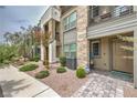Inviting townhome entrance with desert landscaping and stylish stone walkway at 1120 Tektite Ave, Henderson, NV 89011