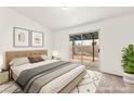 Cozy bedroom with neutral decor, sliding glass door to outdoor patio, and ample natural light at 1405 Wintergreen Dr, Las Vegas, NV 89128