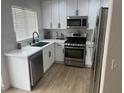 Modern kitchen featuring white cabinets and stainless steel appliances at 1512 Couples St, Las Vegas, NV 89128