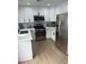 Well-lit kitchen boasts stainless steel appliances and white cabinets at 1512 Couples St, Las Vegas, NV 89128
