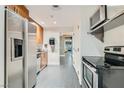 Kitchen featuring stainless steel appliances, modern countertops, and tiled flooring at 200 W Sahara Ave # 1102, Las Vegas, NV 89102