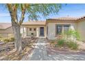 Inviting single-story home with a covered porch, low-maintenance landscaping, and a tile roof at 2292 Saxtons River Rd, Henderson, NV 89044