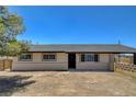 Ranch-style home with a neutral color palette, large windows and a spacious front yard at 2315 Lincoln Rd, Las Vegas, NV 89115