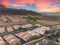 Wide aerial view of residential area showing red-tiled roofs and mountain backdrop at 251 Big Horn Dr, Boulder City, NV 89005
