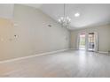 Spacious living room with vaulted ceilings, tile floors, and a stylish chandelier at 2851 S Valley View Blvd # 1039, Las Vegas, NV 89102