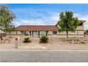 Well-maintained home with rock landscaping, covered entry, and a two-car garage at 301 E Longacres Dr, Henderson, NV 89015