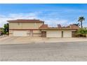 A large three-car garage with a driveway, perfect for car enthusiasts at 301 E Longacres Dr, Henderson, NV 89015