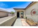 Inviting front porch with tiled walkway, seating area, and decorative sunburst art at 3307 Forestina Ct, Las Vegas, NV 89122