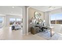 Bright and modern study featuring ample natural light, a stylish desk, and elegant decorative mirrors at 344 Tigullio Ave, Henderson, NV 89011
