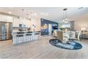 Open-concept living space with modern kitchen, dining area, and a cozy living room at 3782 Neblina Dr, Henderson, NV 89052
