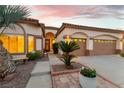 Attractive single-story home with a two-car garage, desert landscaping, and a welcoming entrance at 379 Marlin Cove Rd, Henderson, NV 89012