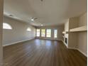 Open-concept living room with wood floors, recessed lighting, fireplace, and a fan at 379 Marlin Cove Rd, Henderson, NV 89012