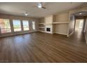 Spacious living room featuring wood floors, a fireplace, recessed lighting, and large windows at 379 Marlin Cove Rd, Henderson, NV 89012