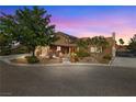 Charming single-Gathering home featuring a brick exterior, lush landscaping, and a two-car garage at 3930 Maranatha Cir, Las Vegas, NV 89103