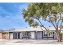 Beautiful single-story home with a tree in front, a freshly painted exterior, and gravel landscaping at 408 Bolsa Dr, Las Vegas, NV 89110