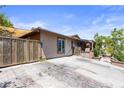 Long driveway leading to a single-story home with gated front entry, and landscaped surroundings at 4606 Powell Ave, Las Vegas, NV 89121