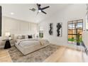 Bright and airy main bedroom with tray ceiling, large windows, and contemporary decor at 4856 Fiesta Lakes St, Las Vegas, NV 89130