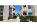 Exterior shot showing a walkway through the condos complex and landscaped grounds at 4941 Newport Cove Dr # B, Las Vegas, NV 89119