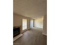 The open living room boasts wood-look flooring and sliding doors for seamless indoor-outdoor flow at 4941 Newport Cove Dr # B, Las Vegas, NV 89119