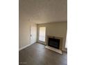 Cozy living room featuring a fireplace, wood-look flooring, and plenty of natural light at 4941 Newport Cove Dr # B, Las Vegas, NV 89119