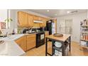 Well-lit kitchen with wooden cabinets, appliances, and a kitchen island at 5674 Moccasin Point St, Las Vegas, NV 89148