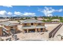 New construction home showing wood framing and a detached garage in a desert setting with city views at 7118 Painted Skyline St, Las Vegas, NV 89118