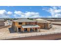 Framed new construction home featuring a detached garage with desert landscape and blue sky at 7118 Painted Skyline St, Las Vegas, NV 89118