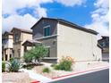 Street view of a two-story home with a covered entryway and low-maintenance desert landscaping at 7411 Sunray Point St, North Las Vegas, NV 89084