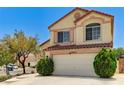 Charming two-story home with a red tile roof, a two-car garage, and desert landscaping at 7521 Reindeer Ct, Las Vegas, NV 89147