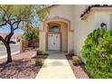 Inviting front entrance showcasing a walkway leading to a double door entry and desert-friendly landscaping at 7521 Reindeer Ct, Las Vegas, NV 89147
