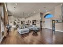 Spacious living room features a large sectional sofa and hardwood floors, perfect for entertaining at 7670 Frittata Ave, Las Vegas, NV 89113