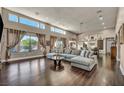 Bright, open living room features high ceilings, clerestory windows, and a modern sectional sofa at 7670 Frittata Ave, Las Vegas, NV 89113