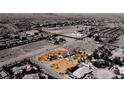 Aerial view showcasing the property's location, surrounded by desert landscape and neighborhood streets at 7720 W Agate Ave, Las Vegas, NV 89113