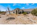 Charming single-story home with a desert landscape, tile roof, and inviting entryway, perfect for relaxation at 7720 W Agate Ave, Las Vegas, NV 89113
