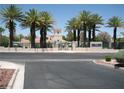 Community clubhouse with well-maintained landscaping, signage, and mature trees at 7955 Canto Ave, Las Vegas, NV 89147