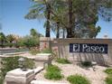 Welcoming entrance to the El Paseo community featuring stone signage and lush landscaping at 7955 Canto Ave, Las Vegas, NV 89147