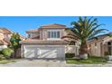 Charming two-story home boasts a three car garage, red tile roof, and lush landscaping at 8083 Shadowvale Dr, Las Vegas, NV 89147