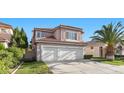 Charming two-story home boasts a three car garage, red tile roof, and lush landscaping at 8083 Shadowvale Dr, Las Vegas, NV 89147