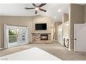 Spacious main bedroom with a fireplace, ceiling fan, and access to a private balcony at 8100 Lake Hills Dr, Las Vegas, NV 89128