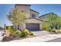 Two-story home showcasing a well-kept front yard, desert landscaping, and a two-car garage at 8254 Palladium St, Las Vegas, NV 89113