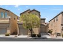 Attractive two-story home with tan stucco, a one-car garage, and a well-maintained front yard with mature tree at 8448 Quarentina Ave, Las Vegas, NV 89149