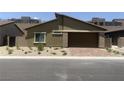 Well-maintained single-Gathering home with desert landscaping and a brick-paved driveway at 901 Heritage Bend Dr, Las Vegas, NV 89138